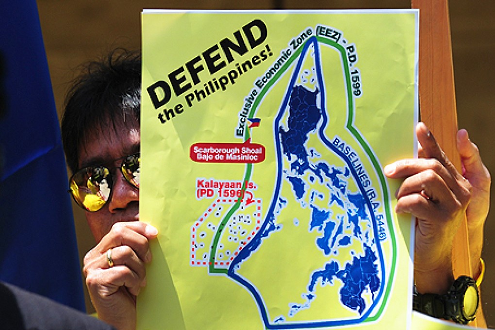 A Filipino holds up a poster of Scarborough Shoal during a protest in Los Angeles, California, in May, as part of a global protest over an escalating territorial row in the South China Sea. Photo: AFP