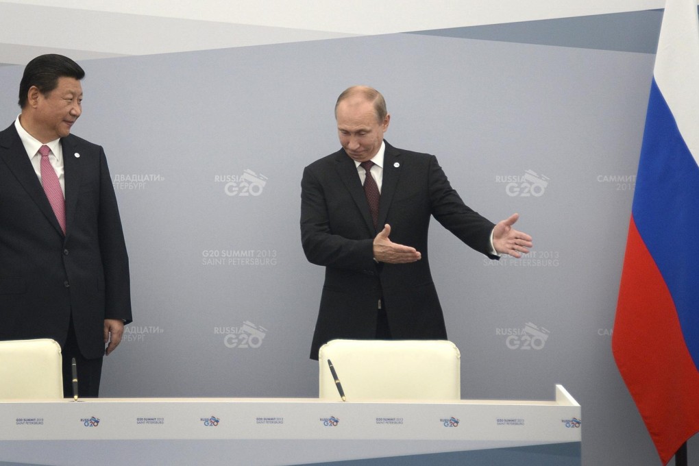 Russian President Vladimir Putin beckons for his Chinese counterpart, Xi Jinping, to sit during talks at the G20 summit in St Petersburg yesterday. Photo: Reuters
