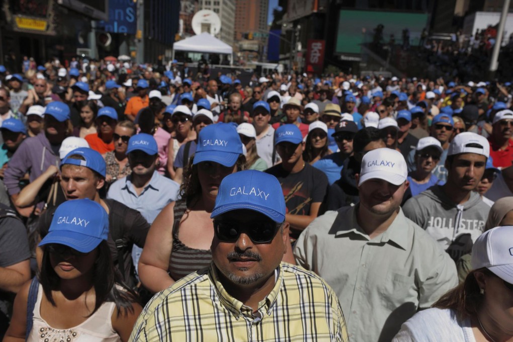 Technology fans crowd into New York's Times Square for a Samsung promotion. Airlines, too, get excited about new products. Photo: Reuters