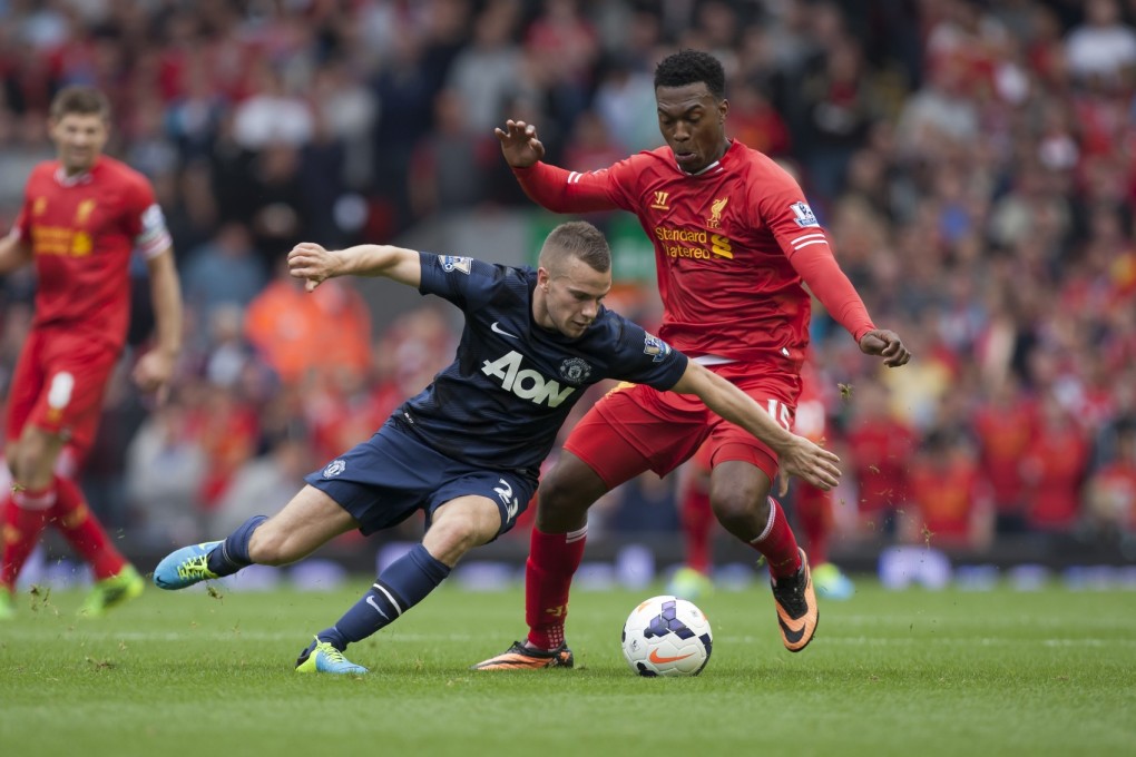 Liverpool's Daniel Sturridge, right, fights for the ball against Manchester United's Tom Cleverley during their English Premier League soccer match at Anfield Stadium, Liverpool. Photo: AP
