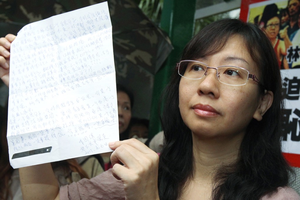 Teacher Alpais Lam Wai-sze shows a threatening letter before reporting to police at Tai Po Police Station. Photo: SCMP