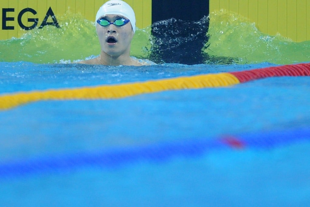 Sun Yang checks his time after the 100m heats. Photo: Xinhua