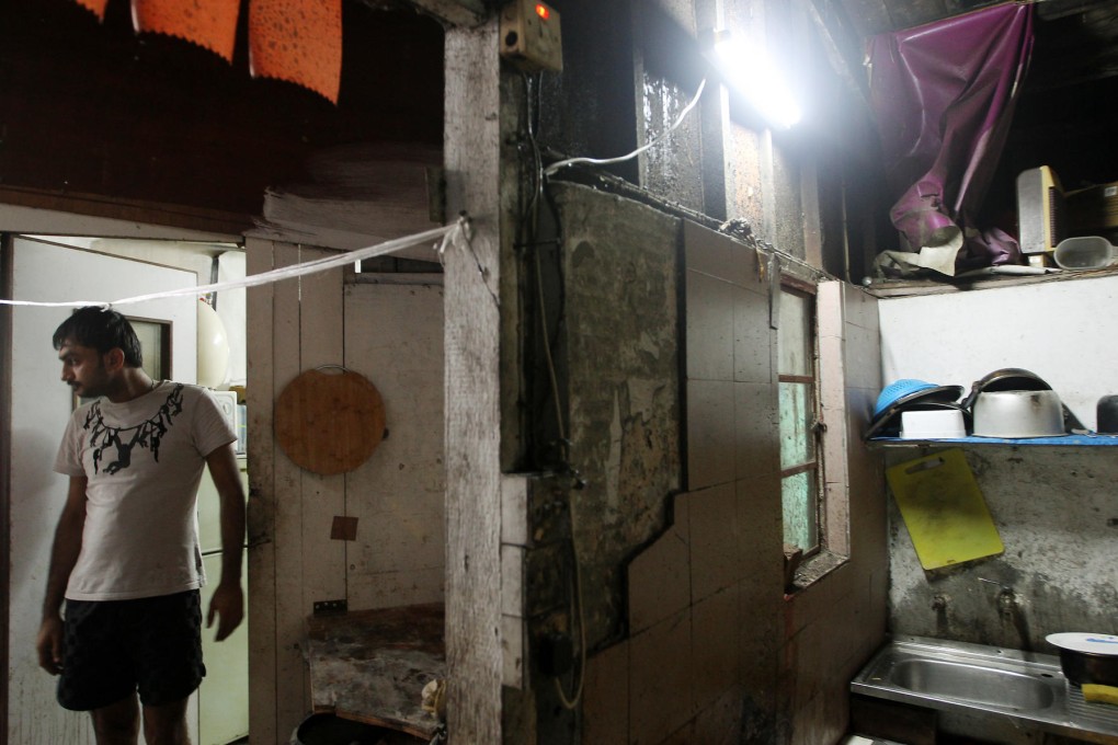 A refugee living in slum conditions in a compound at Lam Tei, Tuen Mun. Many are without basics such as drinking water. Photo: Sam Tsang