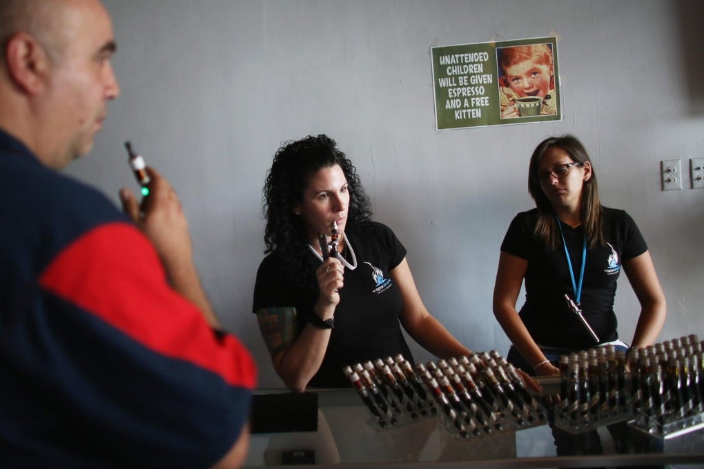A smoker chooses an e-liquid for his electronic cigarette. Photo: AFP
