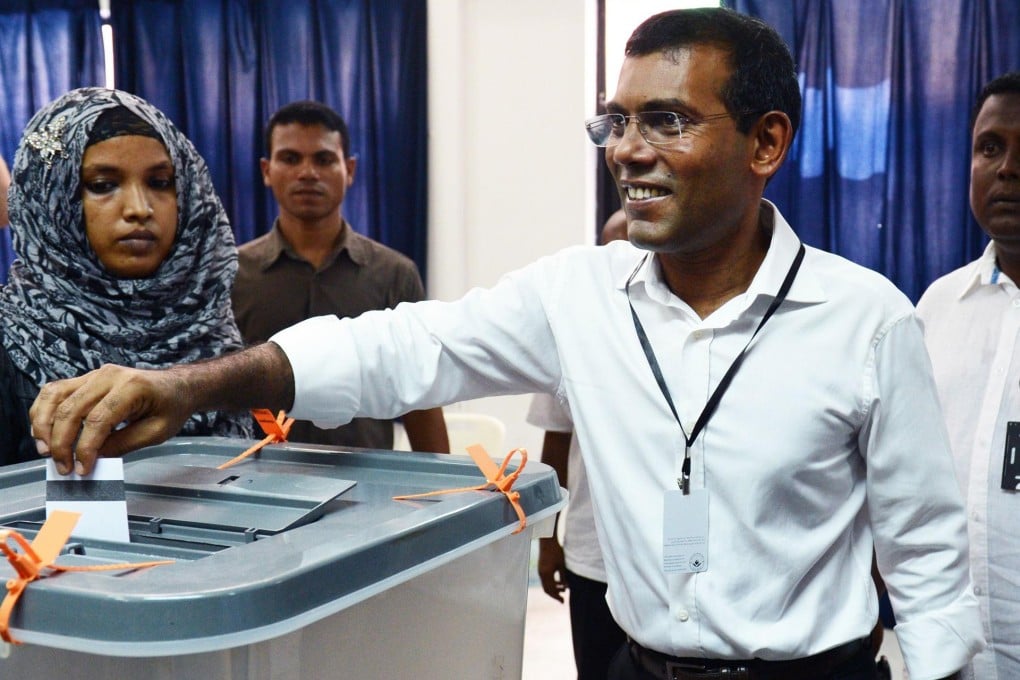 Mohamed Nasheed smiles as he casts his vote. Photo: AFP