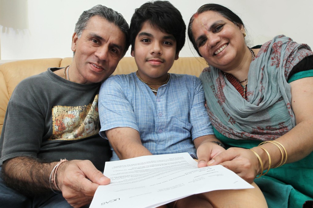 Arjun Singh (centre) with his parents. Photo: Edward Wong