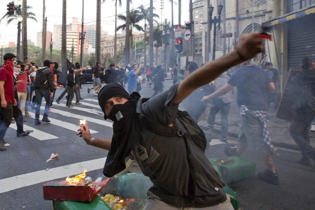 Demonstrators battle police in Sao Paulo during Independence Day protests, while other cities also saw small rallies. Photo: EPA