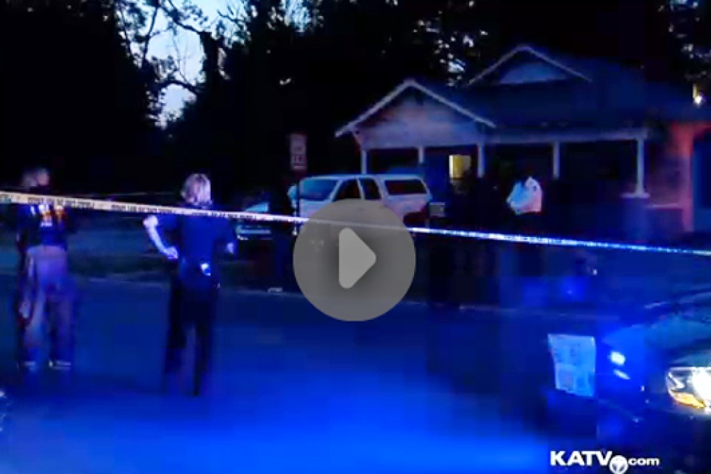 In an image made from video provided by KATV, police surround a home in Pine Bluff, Arkansas. Photo: AP