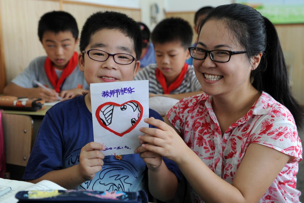 A pupil presents a handmade card to his teacher for Teacher's Day yesterday in Hangzhou, Zhejiang. Photo: Xinhua