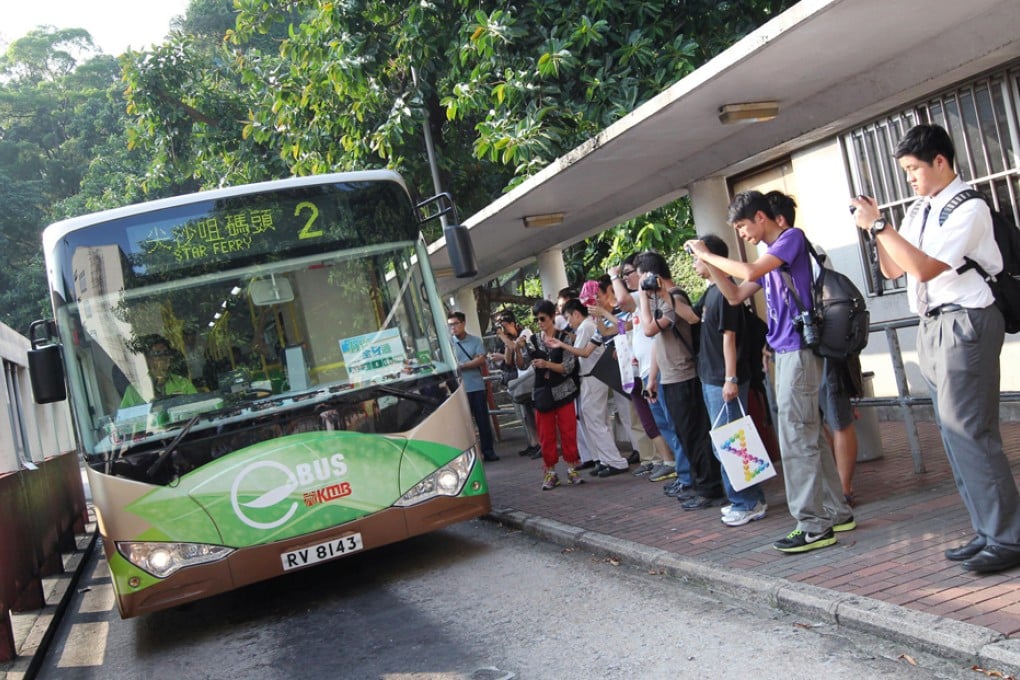 Passengers take a few souvenir snaps before they board the new "eBus" for its first run from So Uk Estate to Tsim Sha Tsui. Photo: Nora Tam