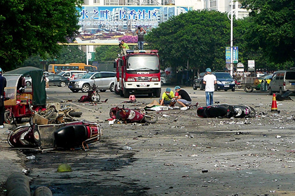 Damaged motorbikes and debris lie on the ground after an explosion outside a primary school in Guilin, southwest China's Guangxi province on Monday. Photo: AFP