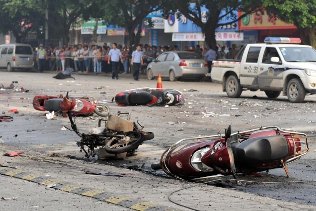 Wrecked motorcycles lie scattered about the road at the blast site near Balijie Primary School. Many of the injured were adults dropping children off for class. Photo: Xinhua