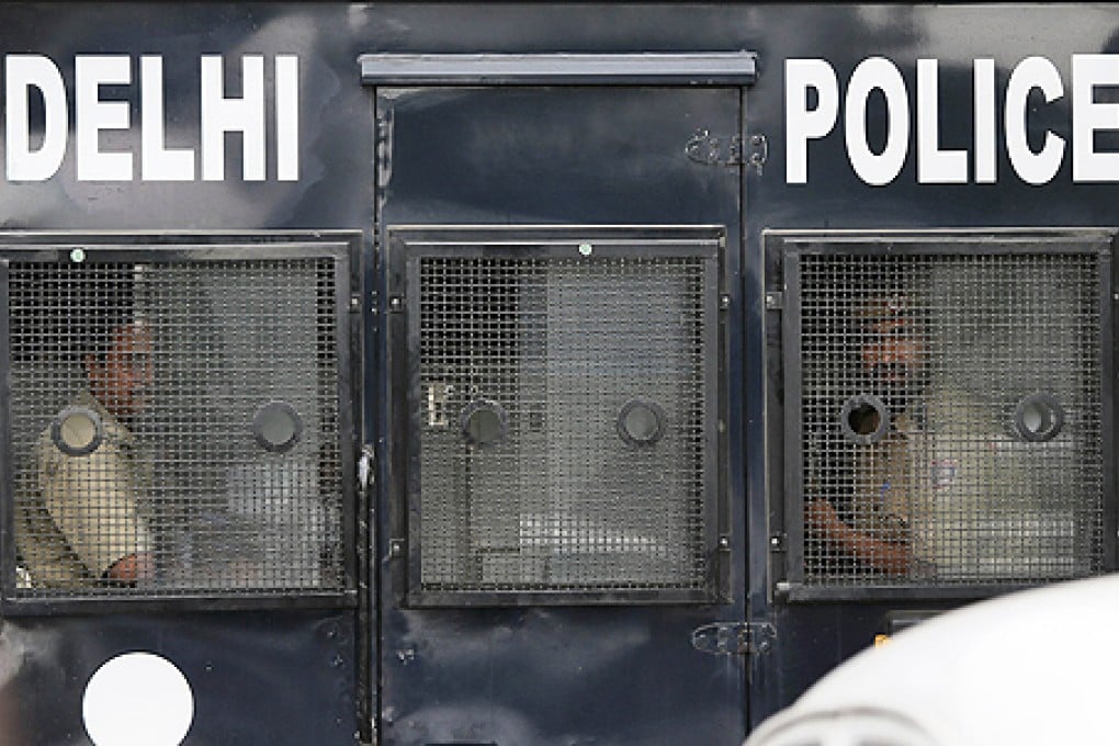 Indian policemen look out from a van carrying four men convicted in the fatal gang rape of a young woman on a moving New Delhi bus last year, in New Delhi, India, on Tuesday. Photo: AP