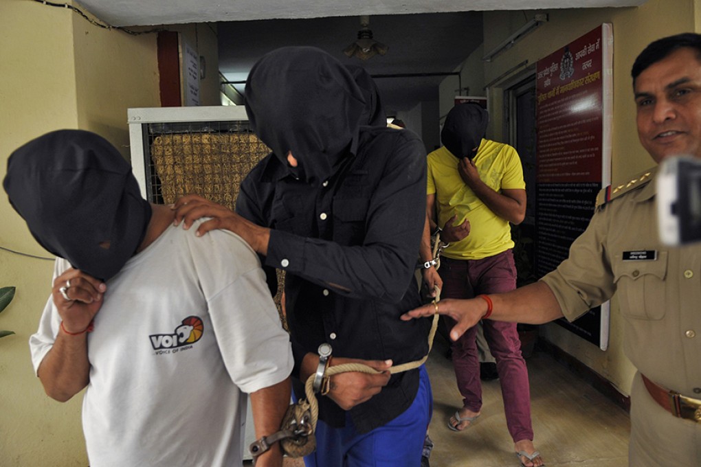 Police escort men accused of a gang rape, outside a police station in New Delhi last month. A report today reveals the shocking extent of rape in Asia-Pacific. Photo: Reuters