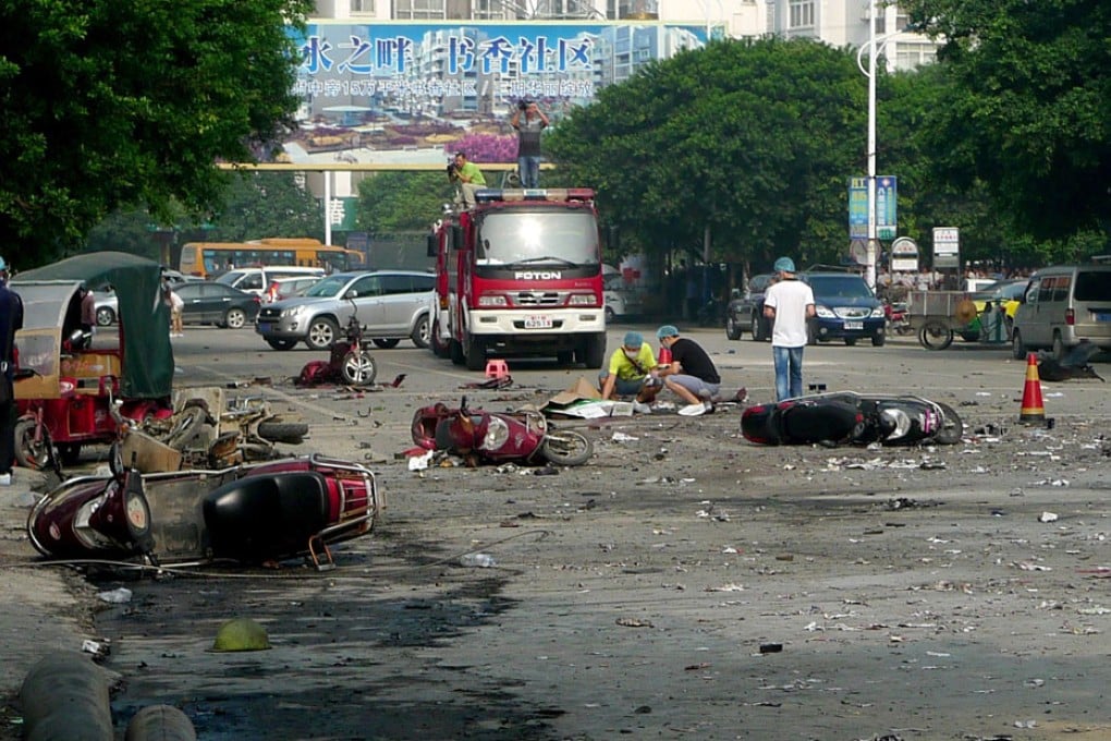 Damaged motorbikes and debris lie on the ground after an explosion outside a primary school in Guilin, southwest China's Guangxi province on Monday. Photo: AFP