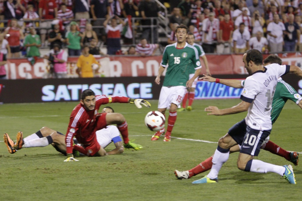 Landon Donovan of the US (right) scores during the World Cup qualifying match against Mexico on Tuesday. Photo: AP