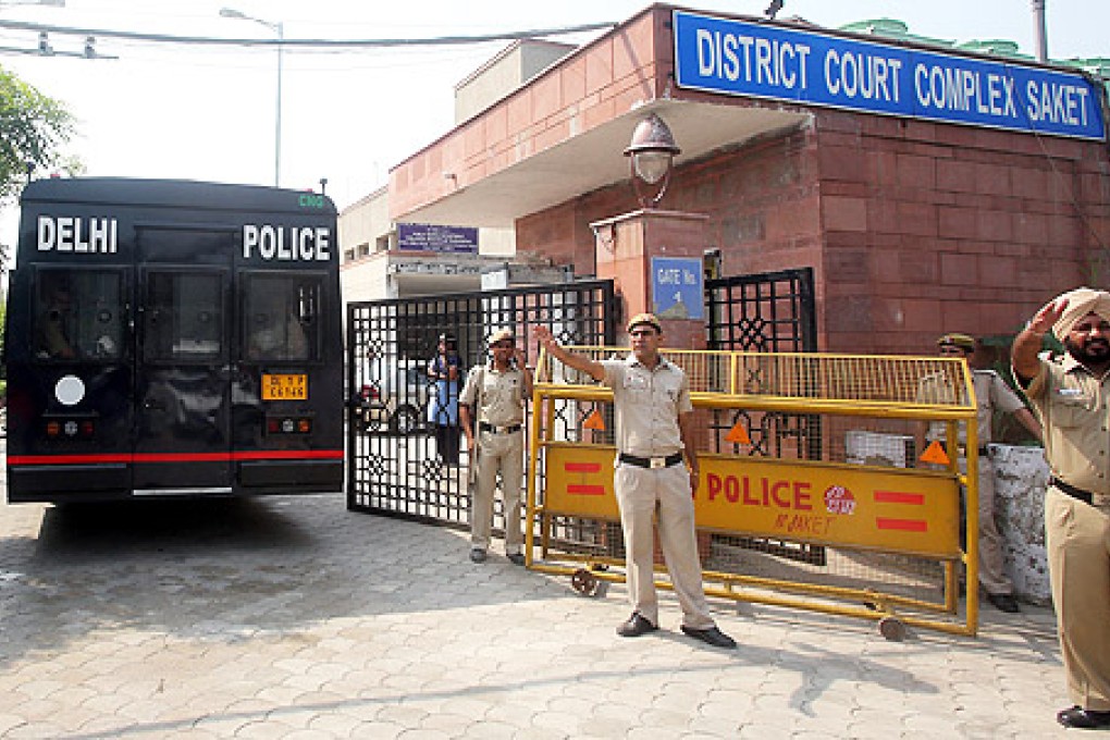 A Delhi police van believed to be carrying the four accused enters the Delhi Saket court complex in New Delhi, India, on Wednesday. Photo: EPA
