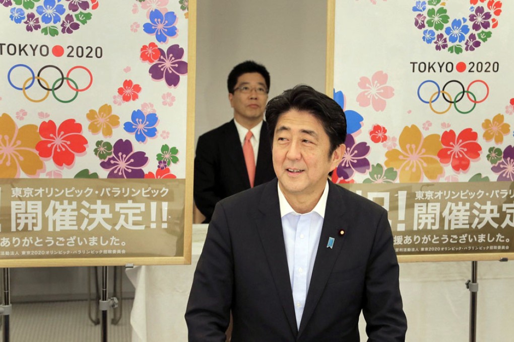 Japan's Prime Minister Abe smiles as he reports to his cabinet members Tokyo's successful bid to host the 2020 Summer Olympics and Paralympics in Tokyo. Photo: Reuters