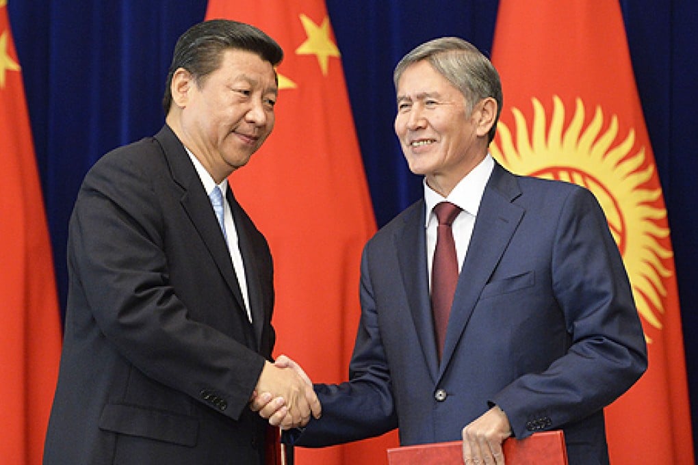 President Xi Jinping (left) and Kyrgyz President Almazbek Atambayev shake hands in Bishkek, Kyrgyzstan on Wednesday. Photo: AP