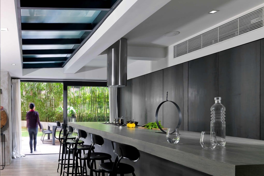 Interior designer Peggy Bels (peggybels.com) designed the kitchen, which was built for about HK$250,000 (excluding appliances). Two metal doors at the back hide the sink area. The counter stools (HK$3,000 each) came from Jerome Lepert in Paris, France (106 Rue Vieille du Temple, tel: 6 10 181 888). Oak flooring was used through much of the flat and cost HK$72 a square foot at Wonderfloor (271 Lockhart Road, Wan Chai, tel: 2728 9373), which also supplied the teak planks used outside (HK$90 a square foot). The circular sculpture is by Nathalie Decoster (www.nathaliedecoster.com).