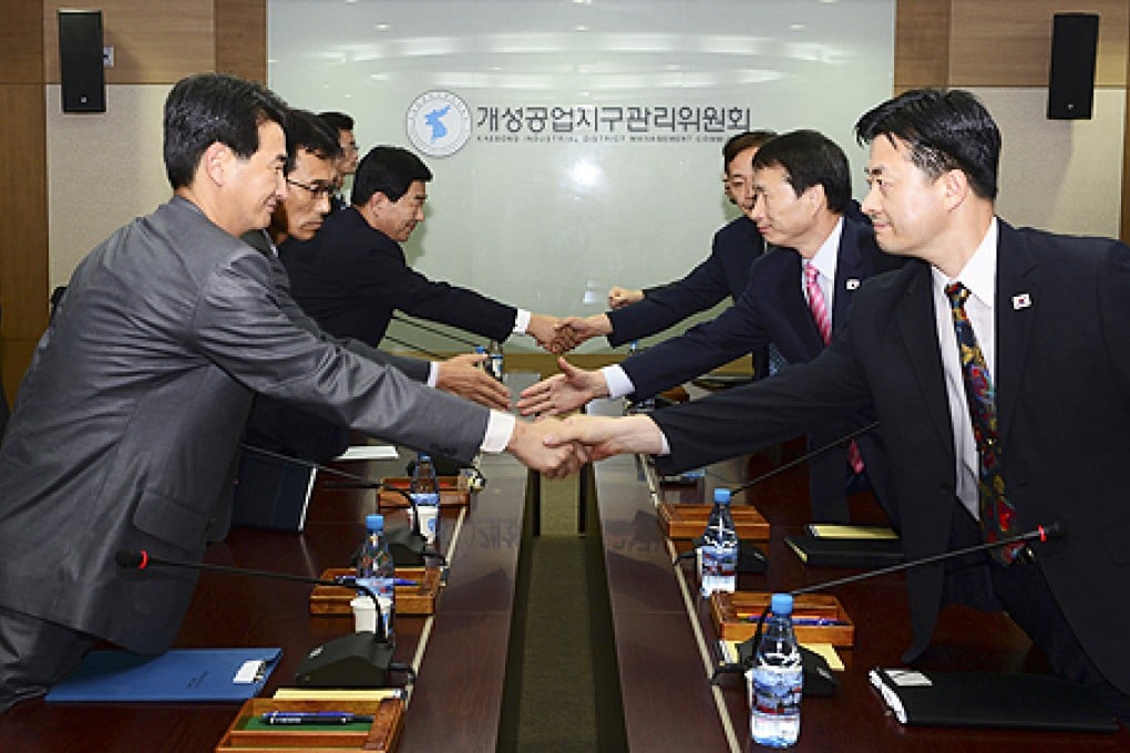 South Korean delegates (right) shake hands with their North Korean counterparts at a meeting at Kaesong Industrial District Management Committee in Kaesong, North Korea, on Wednesday. Photo: AP