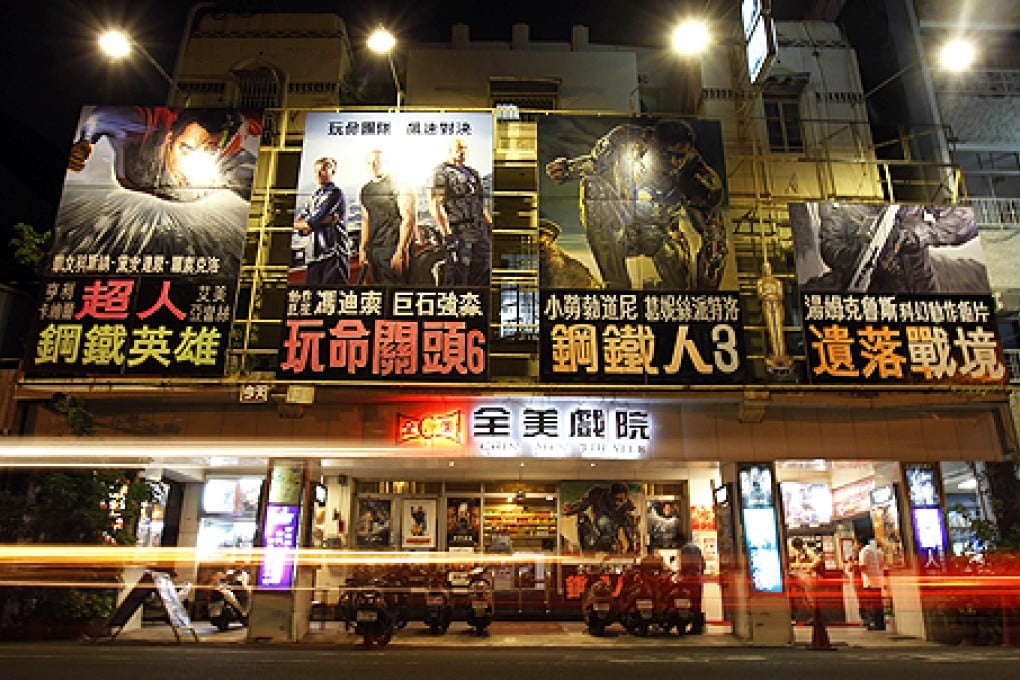 Hollywood movie posters painted by local artist Yan Jhen-fa hang above the entrance to the Chuan Mei Theatre in Tainan, Taiwan. Photo: AP