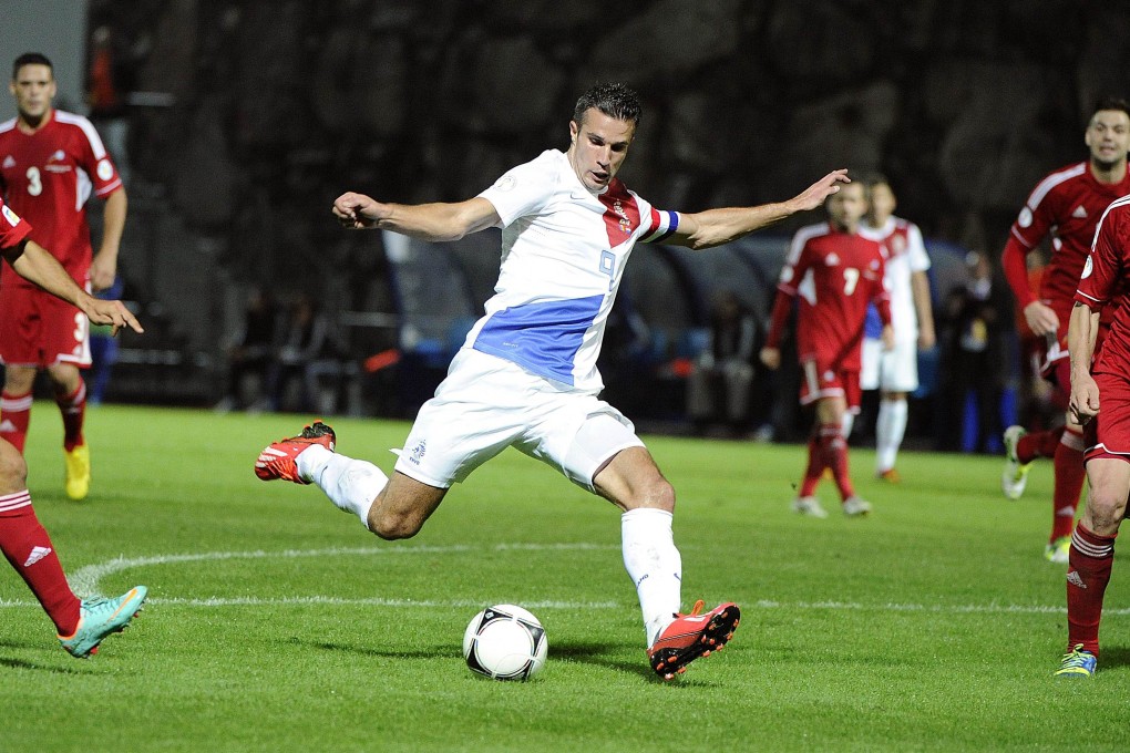 Robin van Persie shoots during the 2014 World Cup match between the Netherlands and Andorra on Tuesday.  Van Persie scored twice as Holland qualified. Photo: AFP