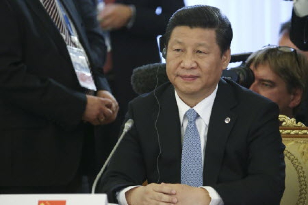 Chinese President Xi Jinping listens during a round table meeting of G-20 leaders in Russia. Photo: AP