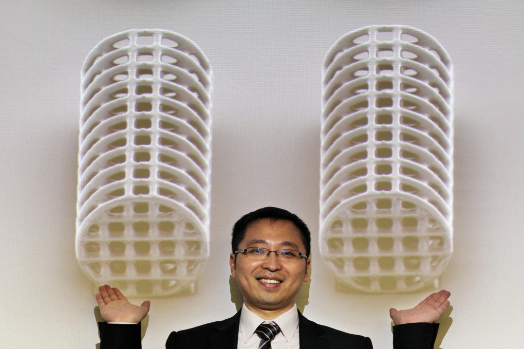 Professor Zhang Li shows enlarged images of his team's medical microbots that are being tested. Photo: Nora Tam