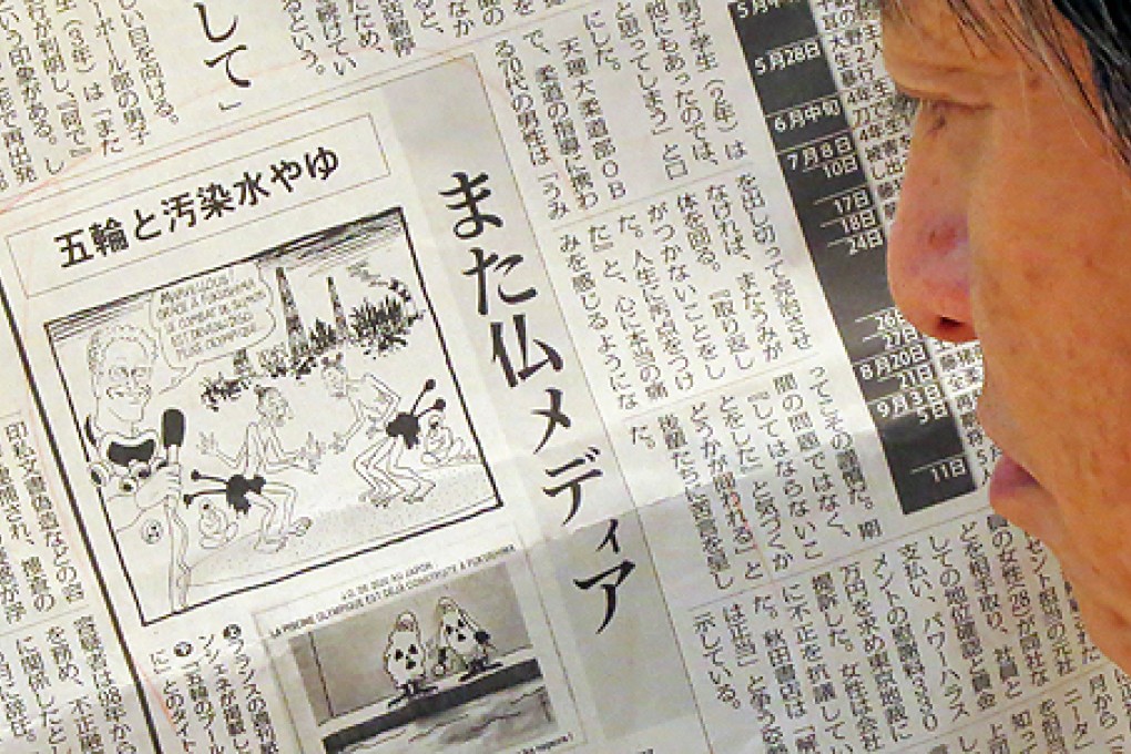 A man reads a Japanese newspaper reporting on cartoons published in a French newspaper, in Tokyo on Thursday. Photo: AFP