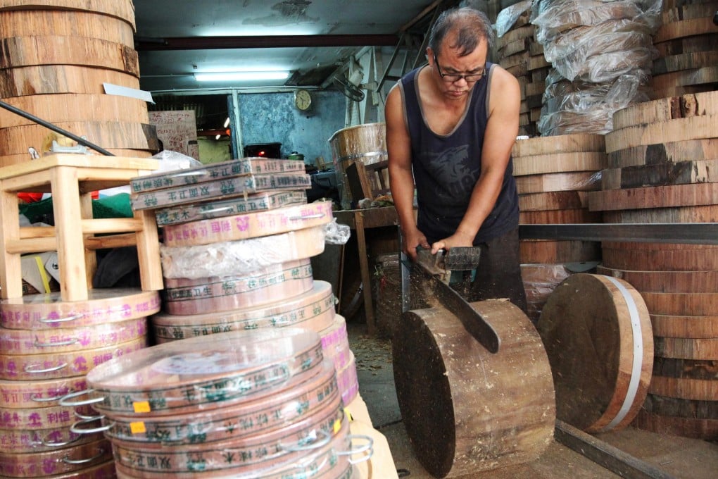 Leung Chun-kit, owner of Lee Hang Cutting Board, goes to work on a block at his shop in Sham Shui Po. Leung has been working in the business for more than 30 years, but says it is doomed. Photo: Nora Tam