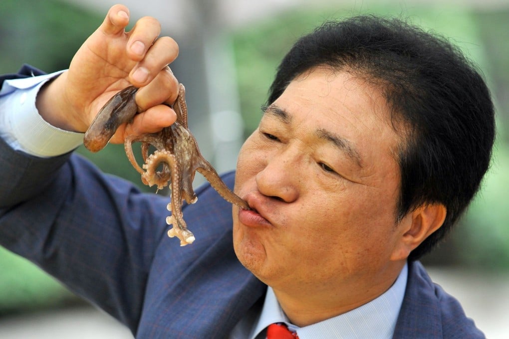 A South Korean man eats a live octopus during a food festival in Seoul. Photo: AFP