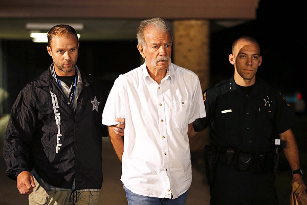 Pastor Terry Jones is escorted to a police car in Lakeland, Florida. Photo: Reuters
