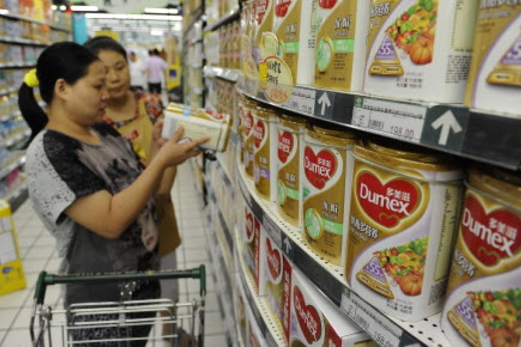 A customer selects milk powder made by Dumex, a subsidiary of France's Danone multinational conglomerate, at a supermarket in Anhui province. Photo: Reuters