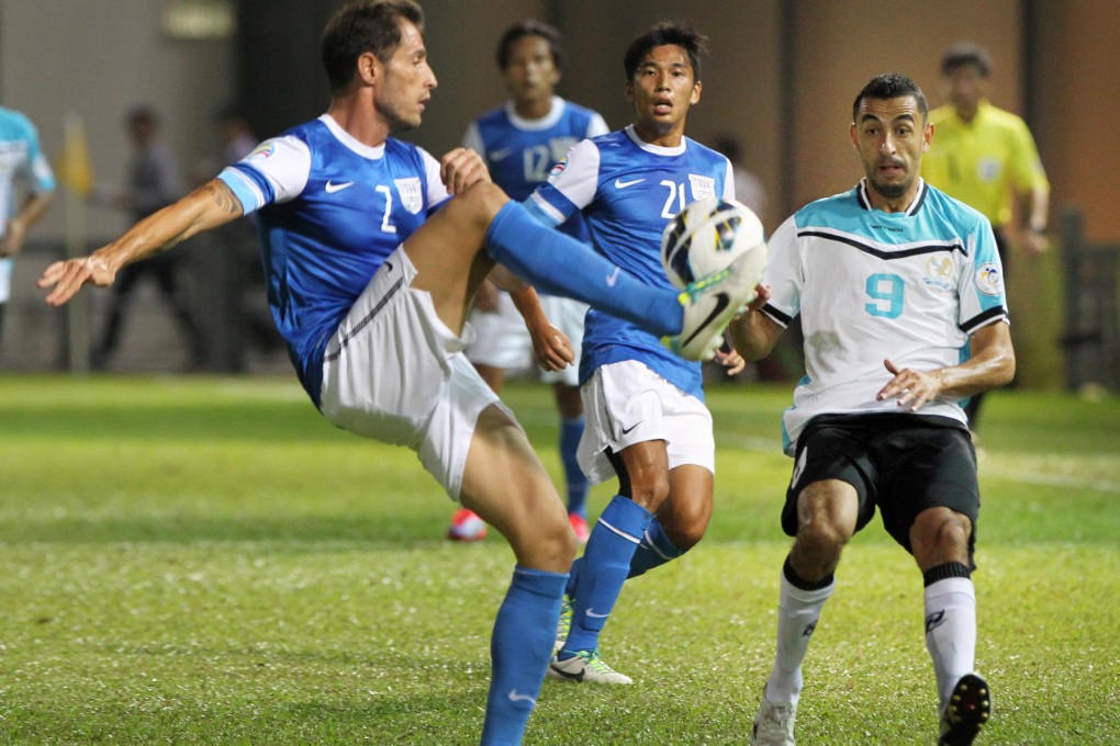 Al Faisaly dangerman Ra'ed Fraeh, who made one and scored one last night, looks on as Fernando Recio Comi clears the ball for Kitchee. Photo: Dickson Lee