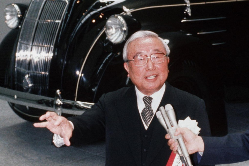 Eiji Toyoda standing in front of Toyota Motor's first vehicle model in a picture taken in April 1989. Photo: AFP