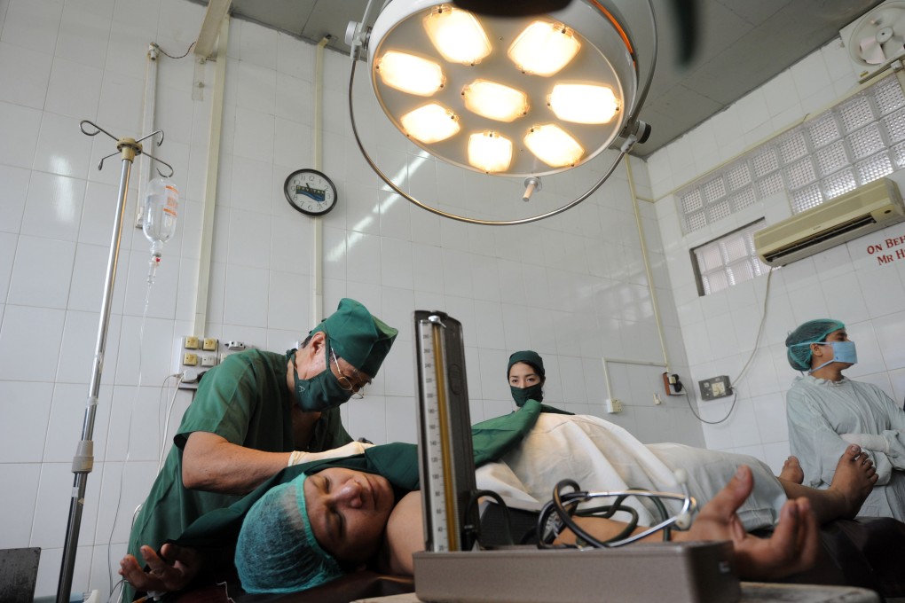 Doctors and medical assistants operating on a patient at the Muslim Free Hospital in Yangon. Photo: AFP
