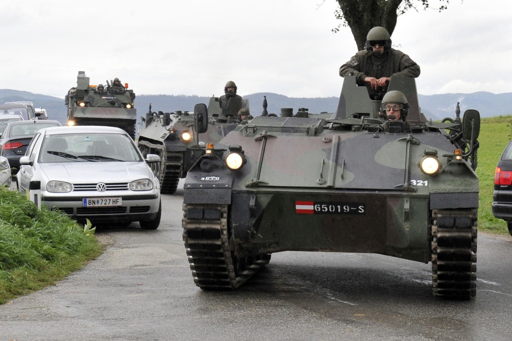 Armoured police vehicles arrive at the farmhouse. Photo: AP