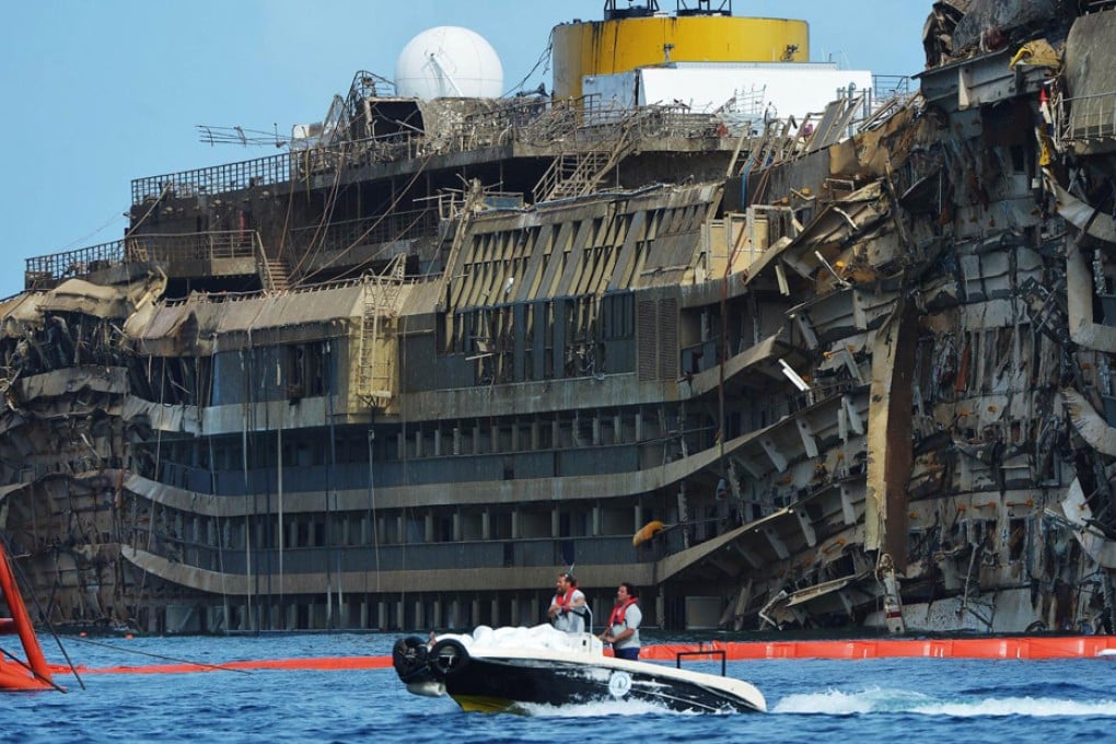 Salvagers pass the wreckage of the Costa Concordia in Italy after it was pulled upright following a 19-hour operation. The ship, which capsized in January last year after sailing too close to shore, will be turned into scrap. Photo: AFP