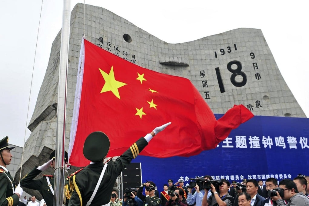 Paramilitary officers hoist the national flag during a ceremony marking the 82nd anniversary of the Mukden incident, in Shenyang, Liaoning province. Photo: Reuters