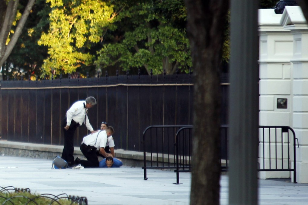 U.S. Secret Service officers detain a man after he reportedly threw firecrackers over the fence of the White House in Washington. Photo: Reuters
