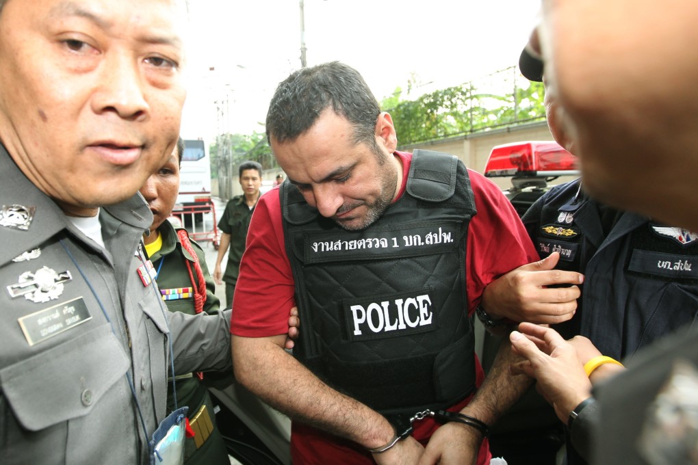 Swedish-Lebanese man Attis Hussein (C) is escorted by Thai police officers as he arrives at the criminal court in Bangkok, Thailand. Photo: EPA