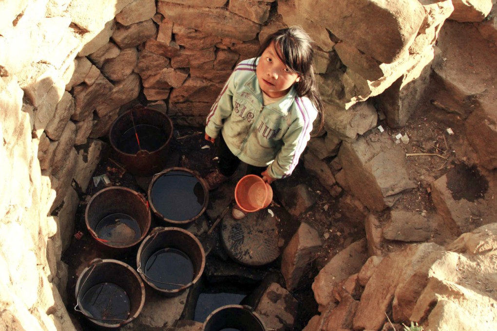 A girl in a dried well in a village of Weining county, Guizhou province. Su Qixiu was trapped in an abandoned well for 15 days. Photo: Reuters