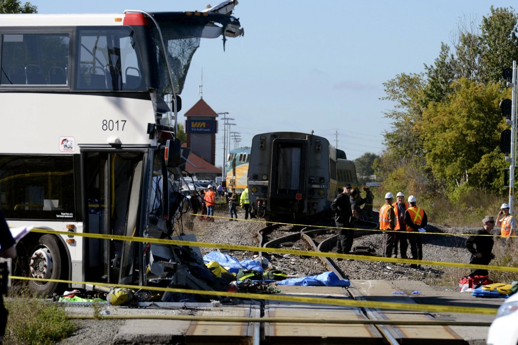 Emergency workers look over the accident scene. Photo: AP