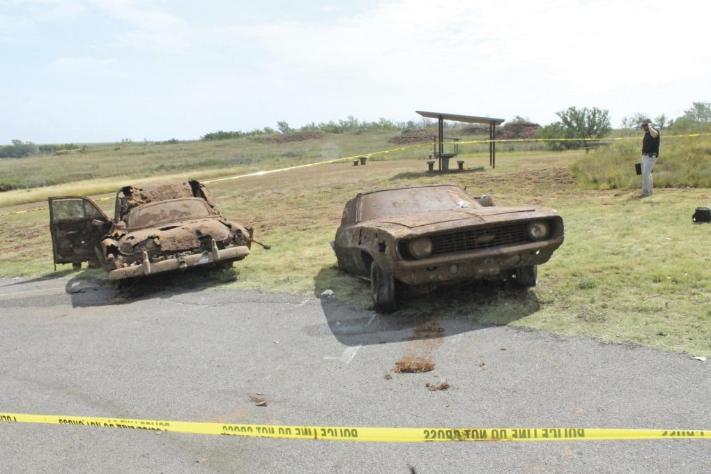 The rusty 1969 Camaro and the 1950s-era Chevy recovered from Foss Lake, Oklahoma. Photo: Reuters