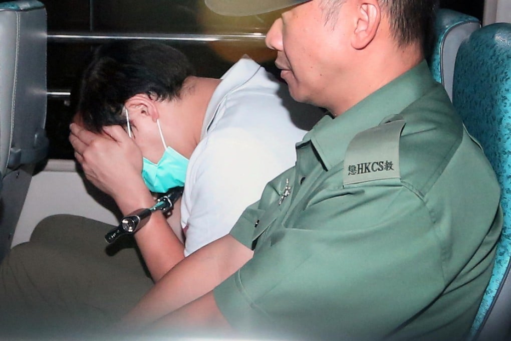 Tai Chi-wai is taken away in handcuffs from the District Court in Wan Chai after being sentenced for abusing his Indonesian maid. Photo: Sam Tsang