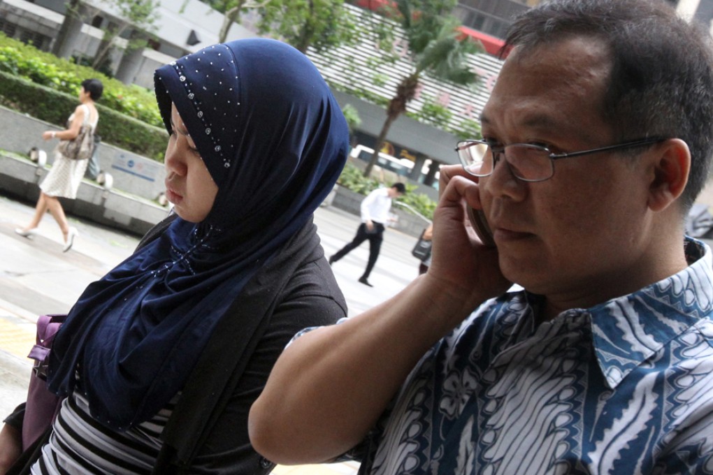 Kartika Puspitasari with a supporter outside court. Photo: David Wong
