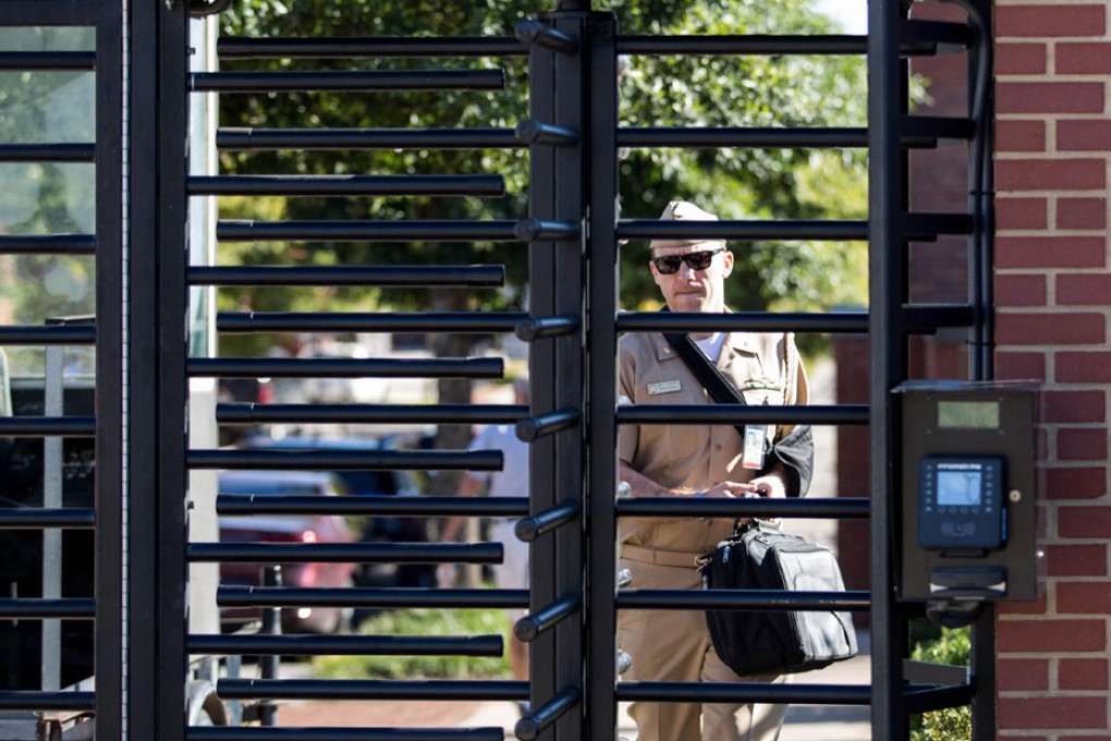 An employee at the gate of the Washington Navy Yard. Gaps in how the US military conducts background checks enabled Aaron Alexis to obtain a high-level security clearance. Photo: AFP