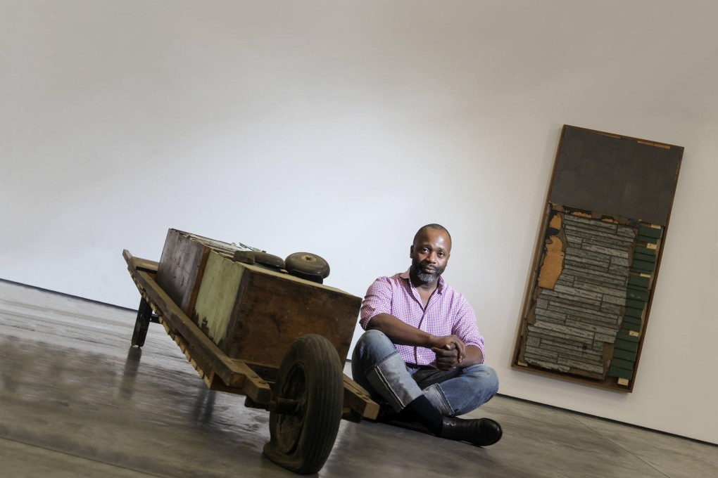 Theaster Gates with some of the works in his exhibition at White Cube gallery. Photo: May Tse