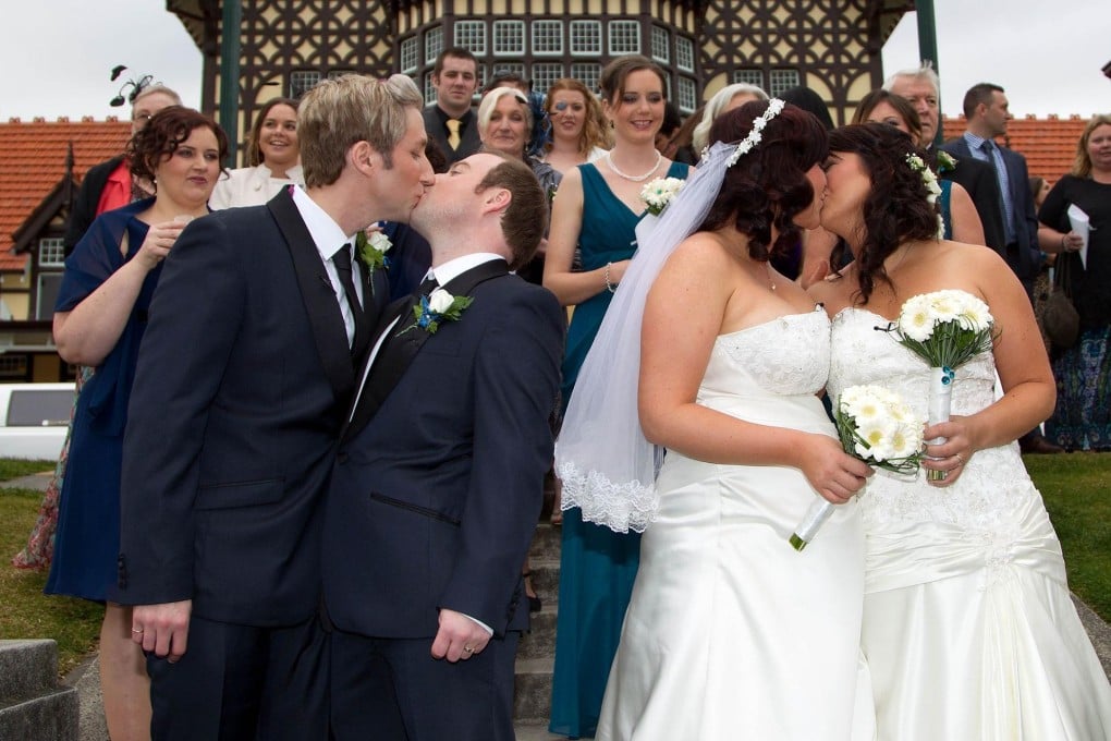 New Zealanders Richard Rawstorn and Richard Andrew and Jess Ives and Rachel Briscoe seal their vows with a kiss. Photo: AFP